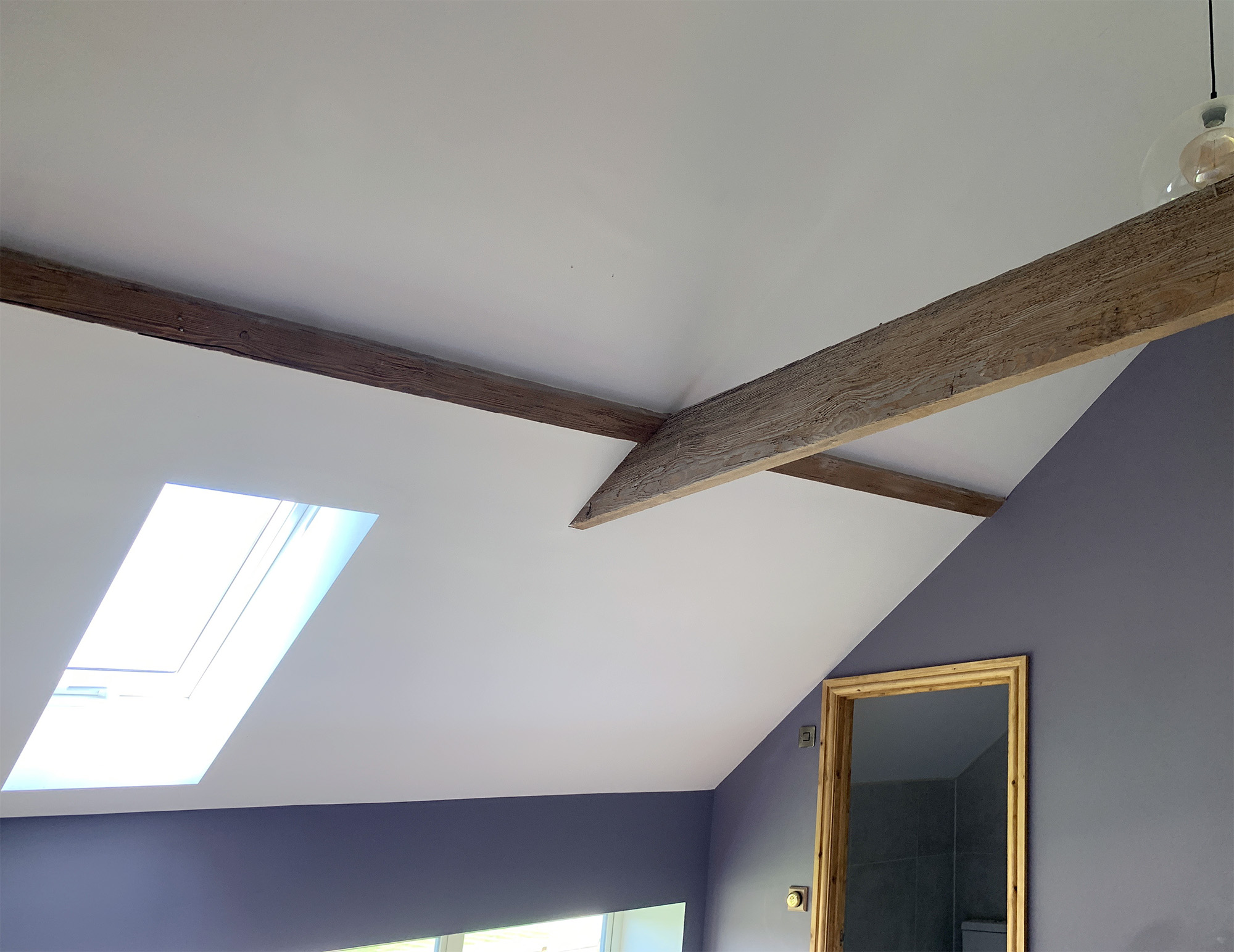 Barn conversion plastered pitched ceiling with beams
