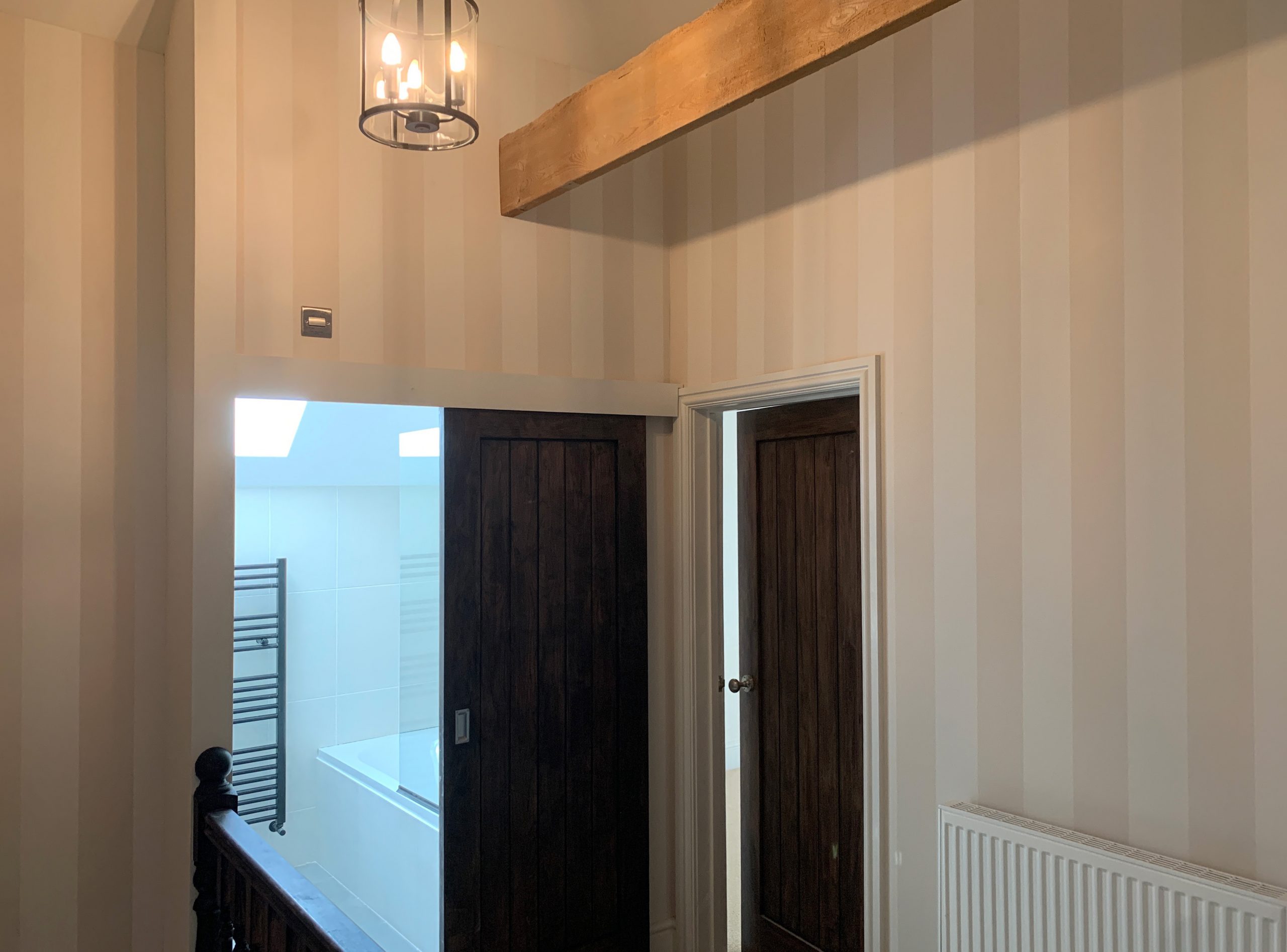 Barn conversion landing plastered and wallpapered