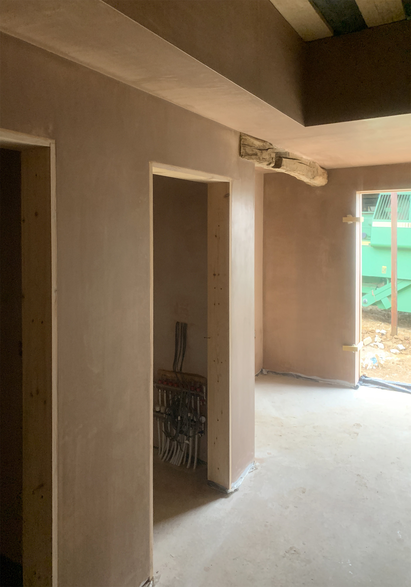 Freshly plastered stud walls in Newark house conversion hallway
